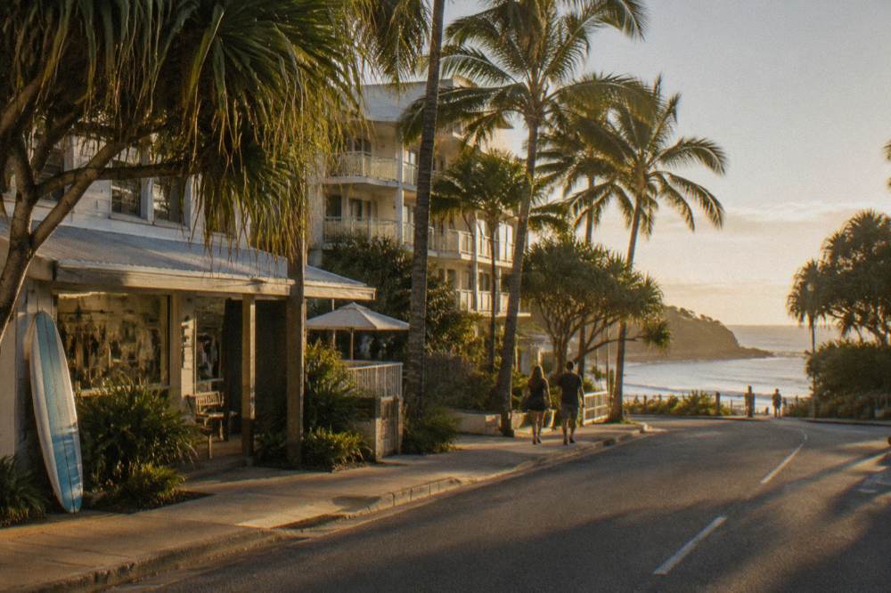 Small coastal town main street with holiday apartments and palm trees